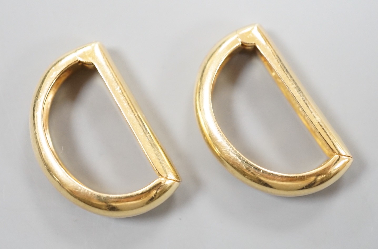 A modern pair of Cartier 750 yellow metal demi-lune cufflinks, each numbered 659650, 24mm, 12.5 grams, in Cartier pouch.